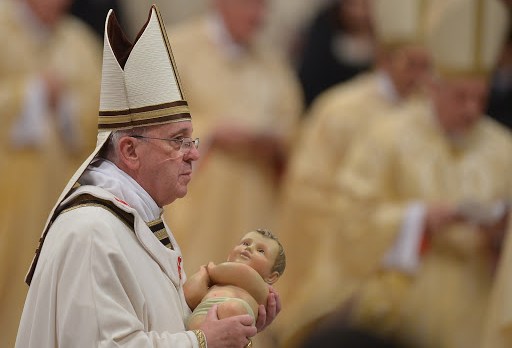 Pope Francis holds the unveiled baby Jesus during a Christmas Eve mass &#8211; es