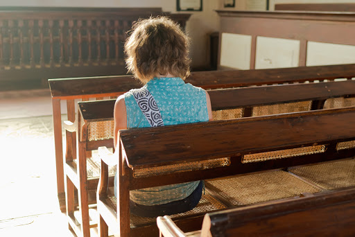 Young woman praying in a church &#8211; es