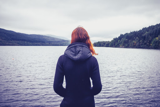 Woman admiring stillness of the lake &#8211; es