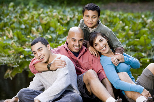Portrait of happy Hispanic family with two boys outdoors &#8211; es