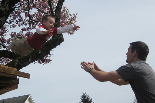A child jumping into the arms of his father &#8211; es