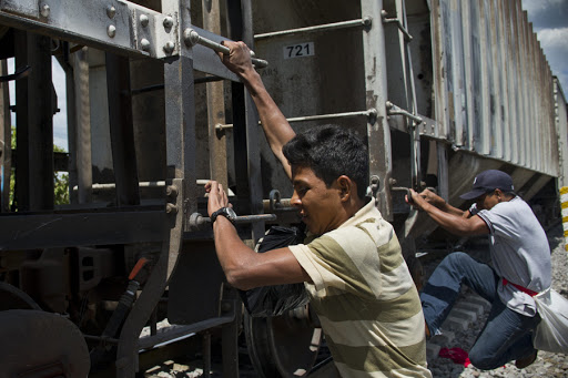 Central American migrants get on the so-called La Bestia (The Beast) cargo train &#8211; es