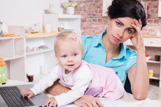 Young business woman with laptop and her baby girl &#8211; es
