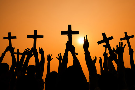 Crosses held up at sunset &#8211; es