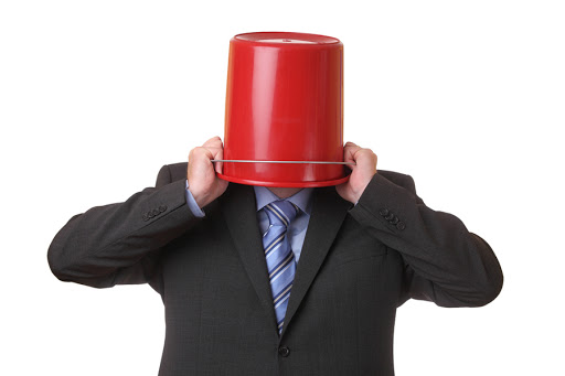 Businessman with a red bucket on his head &#8211; es