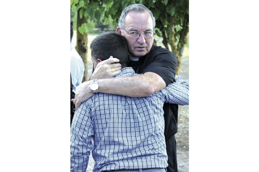 The bishop hugging a boy &#8211; es