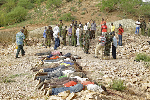Members of the military gather near the bodies of some of the victims of an attack on quarry workers near the town of Mandera, northern Kenya &#8211; es