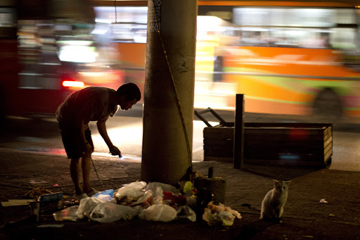 A scavenger spends his christmas eve on street of Manila looking for plastic bottles that he can sell to junkshops. &#8211; es