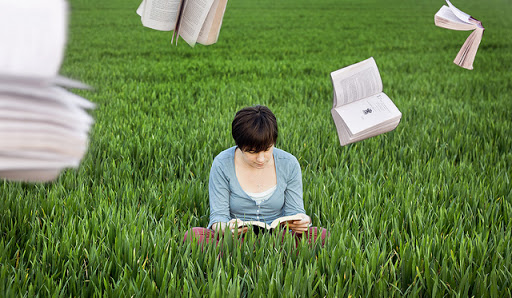 mujer leyendo en un campo verde