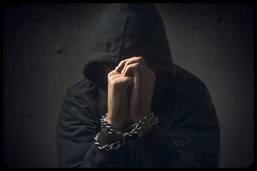 Hands in chains. Arrested man, prisoner, hostage, hopeless and powerless, drug addict, crime concept. &#8211; © igor.stevanovic / Shutterstock &#8211; es