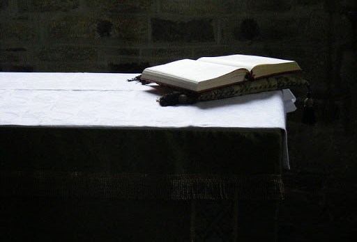 Biblia al costado del altar