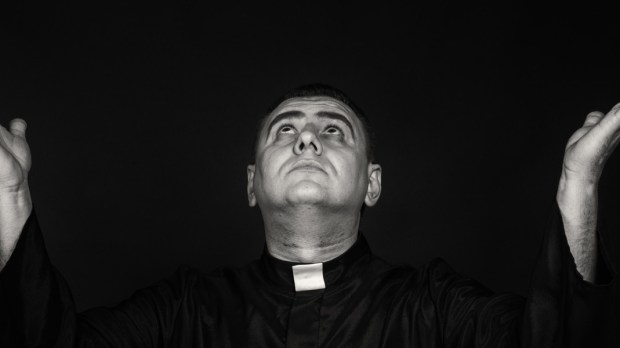 HERO PRIEST GOD HAND BLACK Shutterstock Alexander Lukatskiy ©