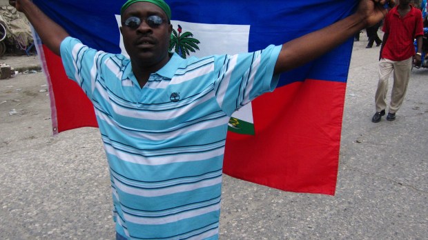 WEB-HAITI-FLAG-DEMONSTRATOR-ELECTIONS-Ben Piven-CC
