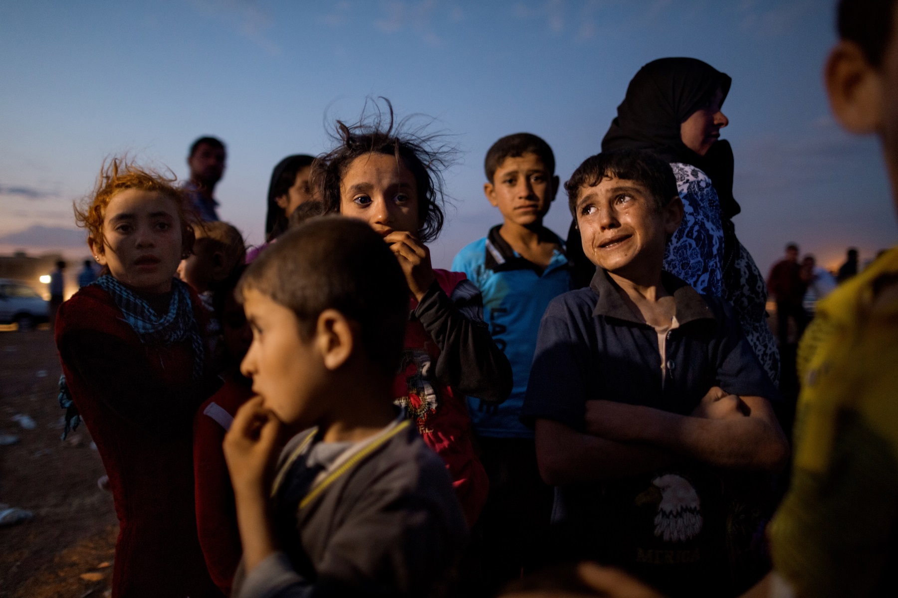 Ahmed, age 5, (right) cries out of fear after crossing into Turkey from Syria with his family Saturday night. Tens of thousands of Kurds fled an Islamic State assault on Kobani in Syria and stream across the border into the Turkish town of Dikmetas on Saturday, September 20, 2014. This was day two of the exodus when 200,000 Syrian's, mostly Kurds, crossed into Turkey in 72 hours.