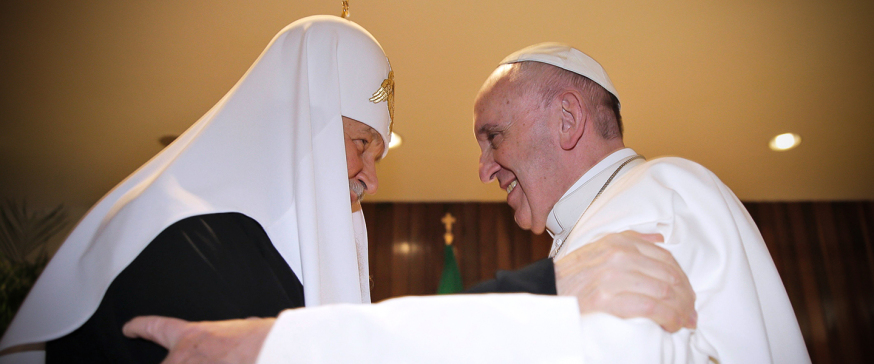 Pope Francis (R) and the head of the Russian Orthodox Church, Patriarch Kirill, greet each other during a historic meeting in Havana on February 12, 2016. Pope Francis and Russian Orthodox Patriarch Kirill kissed each other and sat down together Friday for the first meeting between their two branches of the church in nearly a thousand years. Francis, 79, in white robes and a skullcap and Kirill, 69, in black robes and a white headdress, exchanged kisses and embraced before sitting down smiling for the historic meeting at Havana airport.   AFP PHOTO / MAX ROSSI / POOL / AFP / POOL / Max ROSSI        (Photo credit should read MAX ROSSI/AFP/Getty Images)