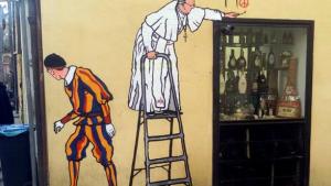 A graffiti depicting Pope Francis and a Swiss guard is seen in Borgo Pio, in Rome