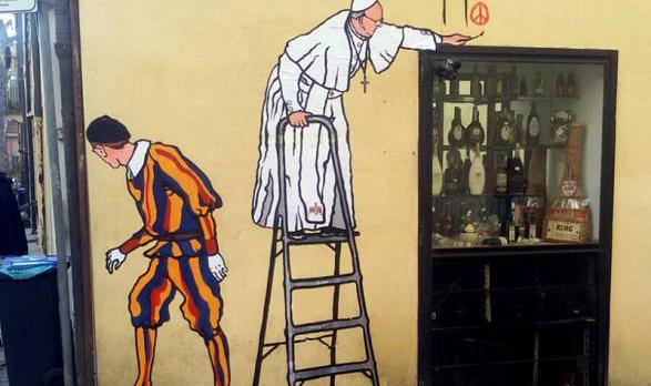 A graffiti depicting Pope Francis and a Swiss guard is seen in Borgo Pio, in Rome