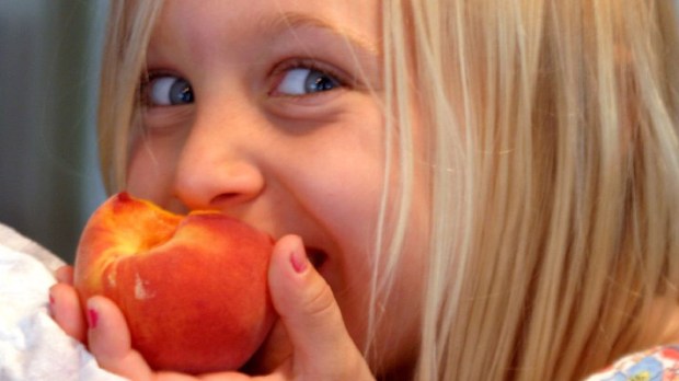 hero-eating-happy-girl-peach-bruce-tuten-cc