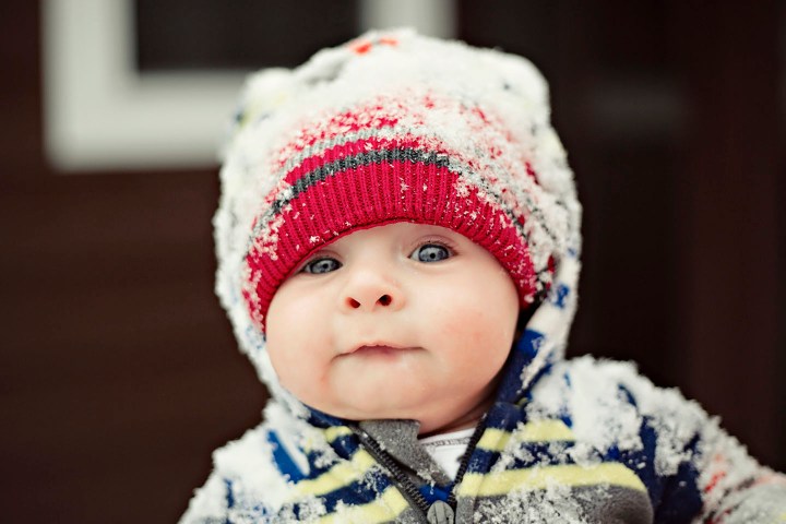 Baby With Blue Eyes Wearing A Hat