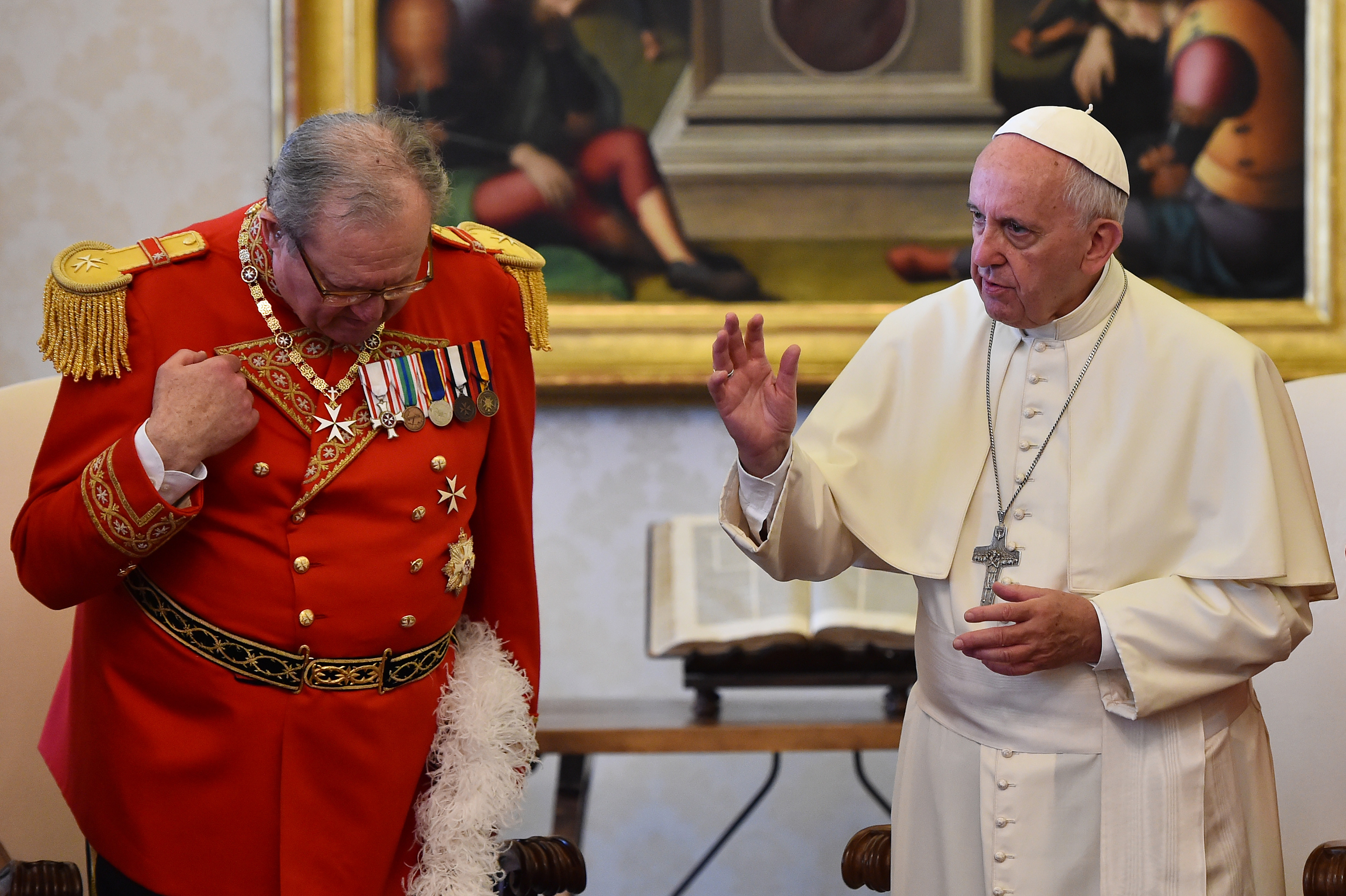 Pope Francis makes the sign of the cross next to Robert Matthew Festing, Prince and Grand Master of the Sovereign Order of Malta during a private audience on June 23, 2016 at the Vatican. / AFP PHOTO / POOL / GABRIEL BOUYS