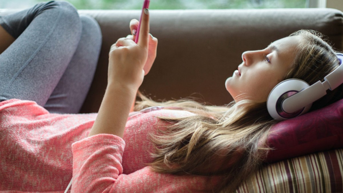 web3_teenage_girl_smartphone_headphones_boring_carolyn_lagattuta_-_stocksy_united