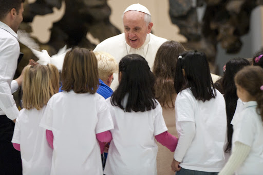 Pope Francis is welcomed by children