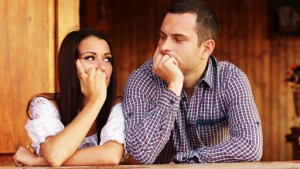 Young thinking couple looking at each other