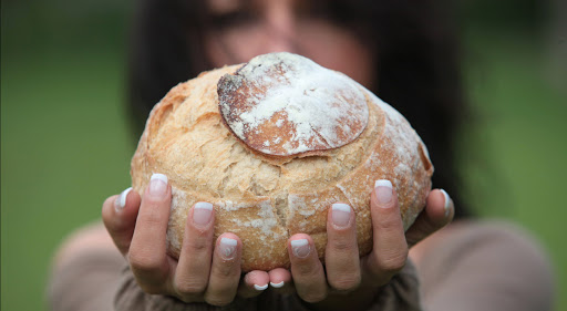 Bread into woman hands during Lent &#8211; fr
