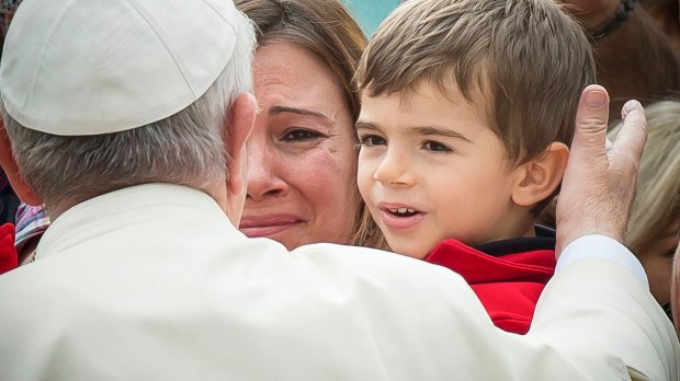 Pope Francis blessing a child with his Mother