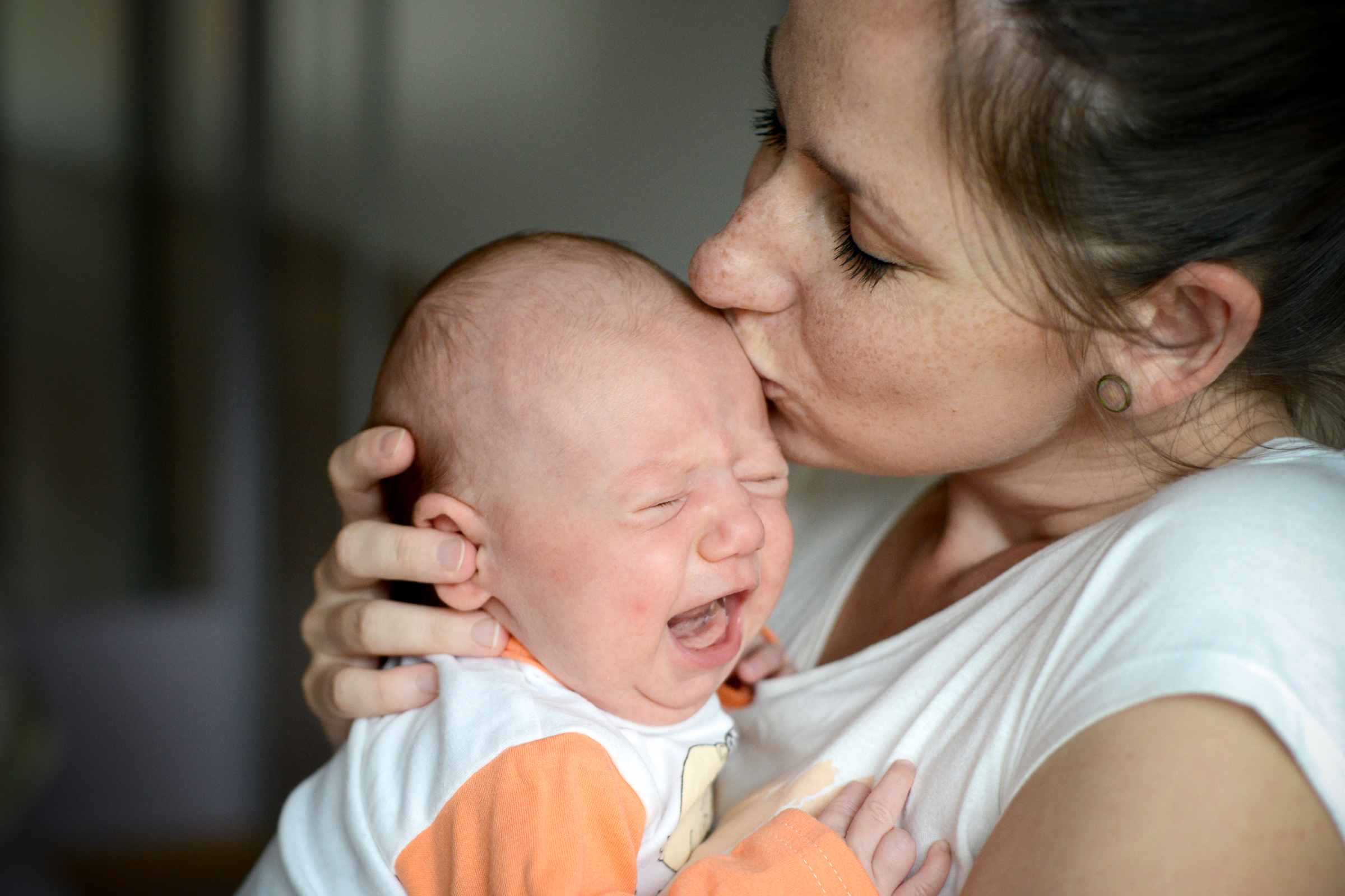 web-infant-crying-baby-mother-kiss-halfpoint-shutterstock_417498310