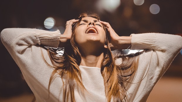 WEB3-ANGER-MAD-SCREAMING-WOMAN-NIGHT-ARMS-UP-EMOTIONS-GRSI-Shutterstock