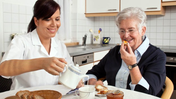 WEB3-geriatric nurse helps elderly woman at breakfast-shutterstock_89251555-Lisa S.-AI