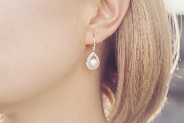 Detail of young woman wearing beautiful luxury earring