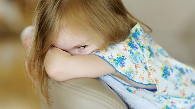 WEB3-CHILD-GIRL-ANGRY-UPSET-SOFA-COUCH-STARE-Shutterstock