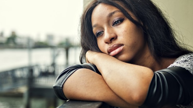 WEB3 SAD WOMAN ALONE PENSIVE AFRICAN AMERICAN Shutterstock