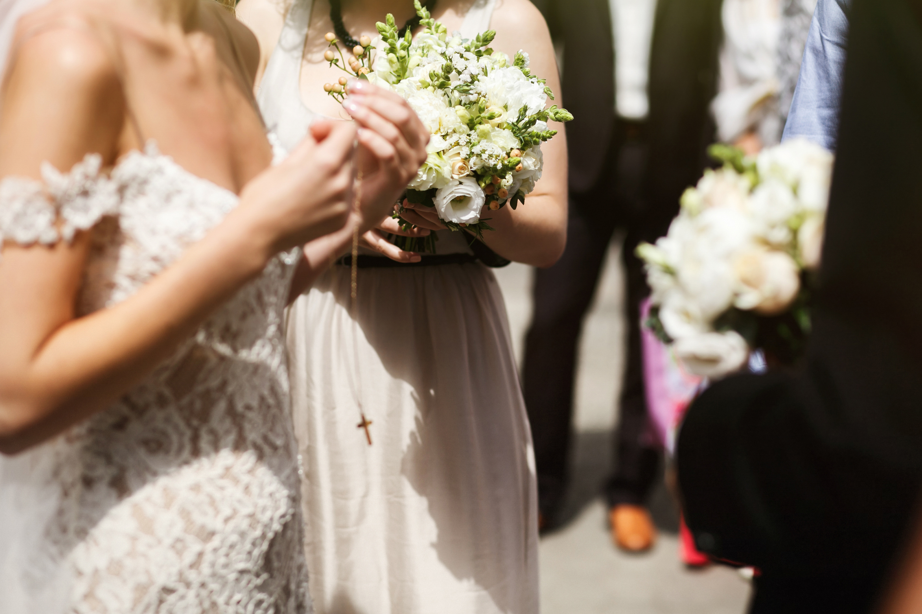 Emotional beautiful brunette bride in white vintage dress puttin