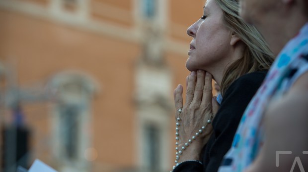 A Woman Praying the Rosary