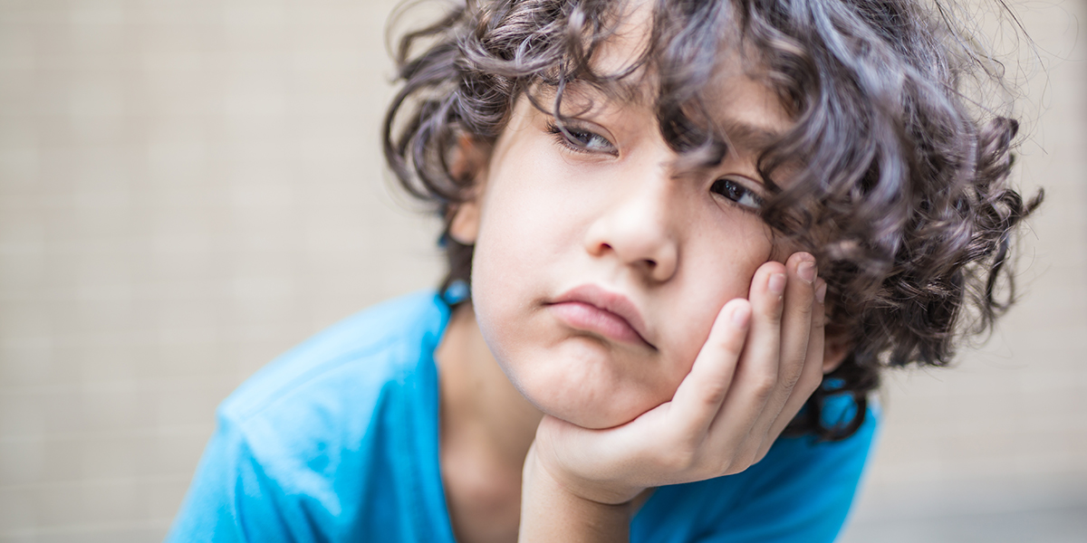 WEB3-BORED-CHILD-THINKING-BOY-CURLY-HAIR-Shutterstock