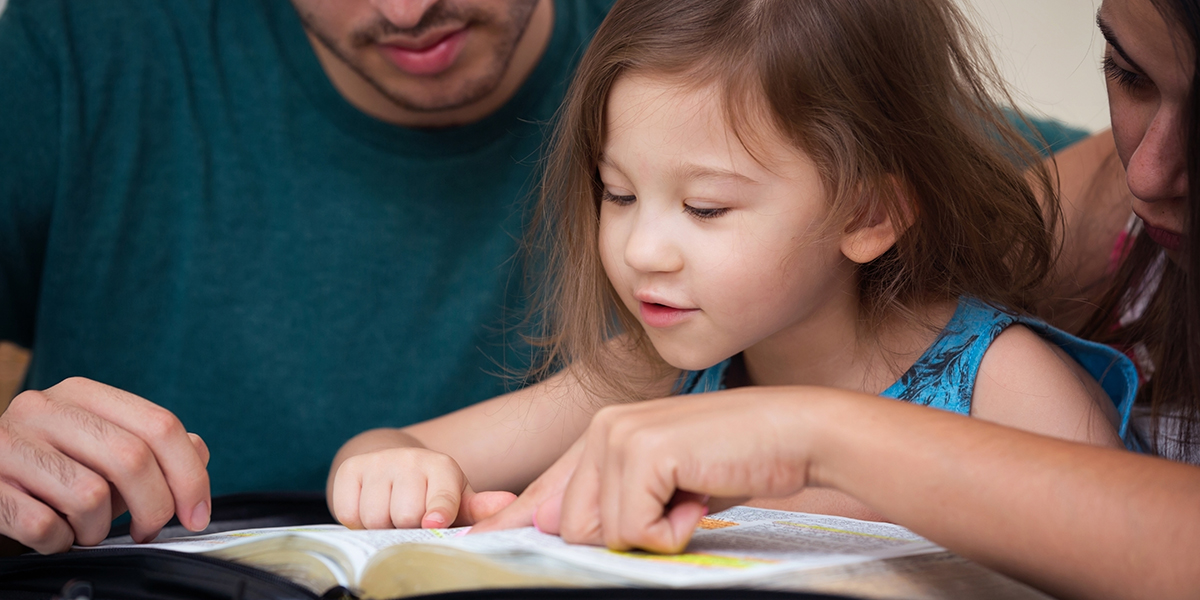 WEB3-FAMILY-FATHER-MOTHER-DAUGHTER-GIRL-READING-TEACHING-BIBLE-shutterstock_470690663-Shutterstock