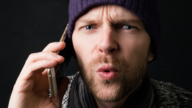 WEB3-MAN-SPEAKING-PHONE-CELL-DEVICE-HAT-ANGRY-CURIOUS-shutterstock_515631433-Shutterstock