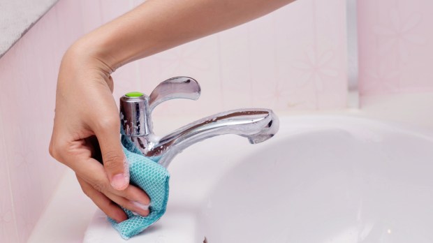 WEB3 WOMAN HAND CLEANING BATHROOM SINK HOUSEWORK Shutterstock