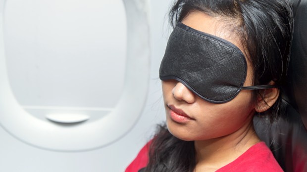 WEB3 WOMAN RELAX AIRPLANE PLANE SLEEP SLEEPING EYE MASK TRAVEL Shutterstock