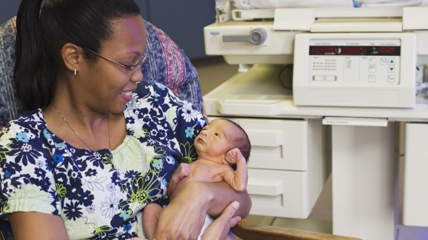 WEB3 BABY HOSPITAL NEWBORN MOM ROCKING CHAIR HOLDING A BABY Shutterstock