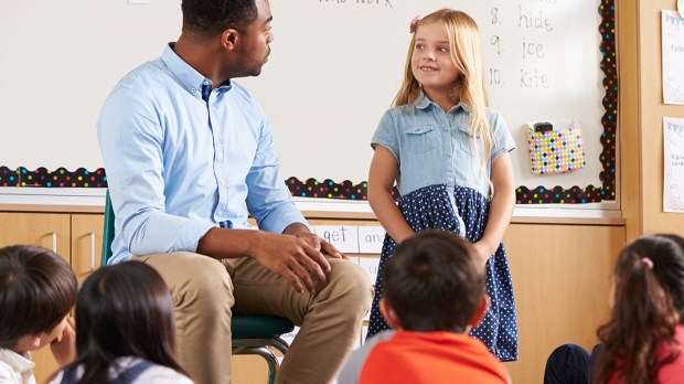 WEB3-CHILDREN-SCHOOL-TEACHER-MAN-TALKING-LISTENING-CIRCLE-Shutterstock