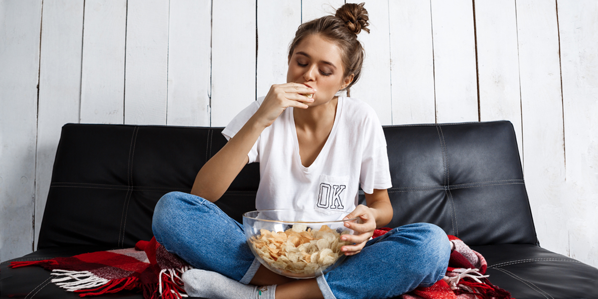 WEB3 TEEN COUCH FOOD SEDENTARY LAZY COUCH POTATO COLLEGE Shutterstock