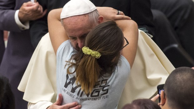 A Woman embraces Pope Francis