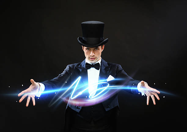 magician in top hat showing trick stock photo