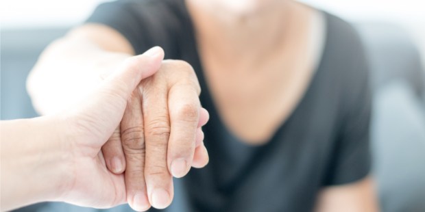 WOMAN HELPING ON OLD ONE