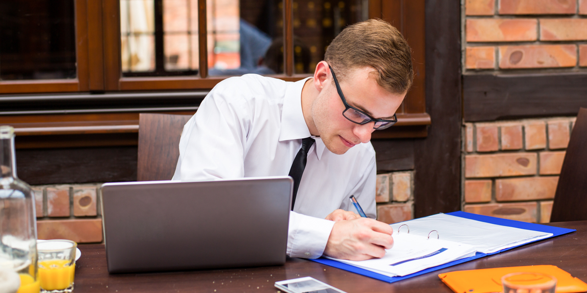 MAN WORKING AT DESK
