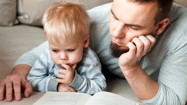 Ojciec czytający książkę synowi